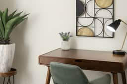 A peaceful corner to catch up on work or jot down travel plans, complete with a modern desk, task lamp, and minimalist wall décor.